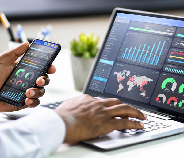 a person using a laptop and a phone